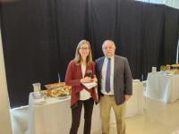 Man and woman in front of tables at conference